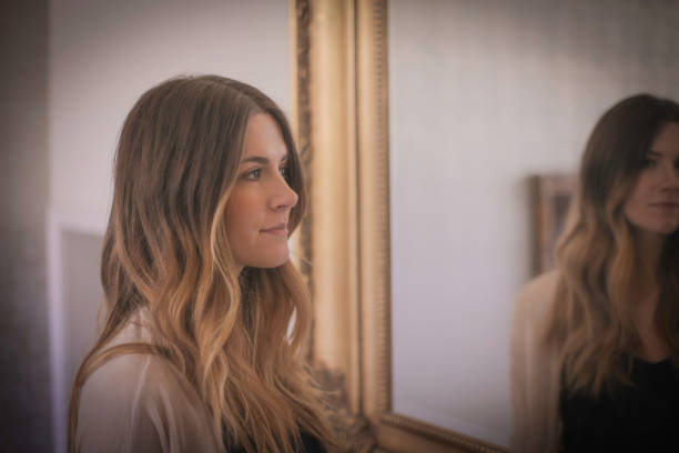 istock Woman with mirror behind her 502315682