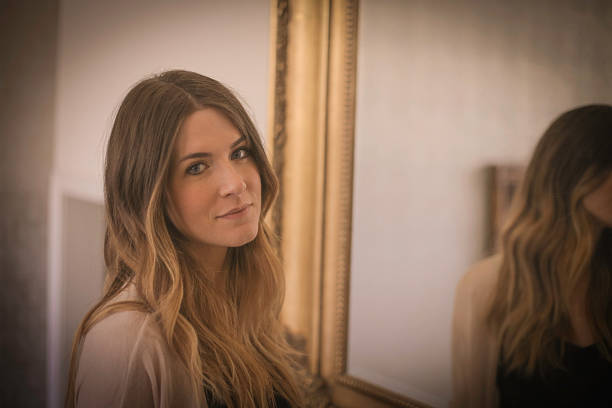 istock Woman with mirror behind her 502315704