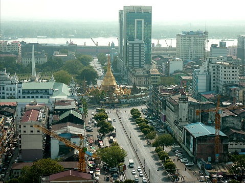 Yangon downtown cityscape view from Sakura tower. In the background the golden Sule Pagoda and Yangon river, 