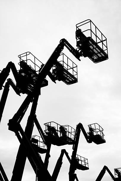 istock Group of cherry pickers silhouetted. 502317678