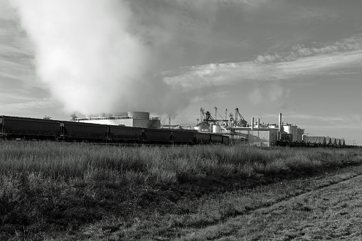 B&W image of CO2 rising from industrial complex.