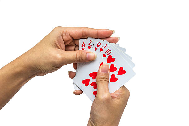 istock Playing cards in hand isolated on white background 502319816