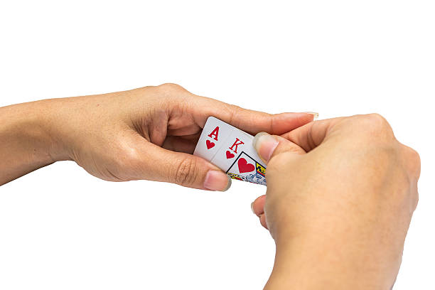 istock Playing cards in hand isolated on white background 502320028