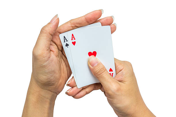 istock Playing cards in hand isolated on white background 502320410
