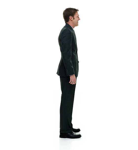 istock Smiling businessman standing and looking away 502320692
