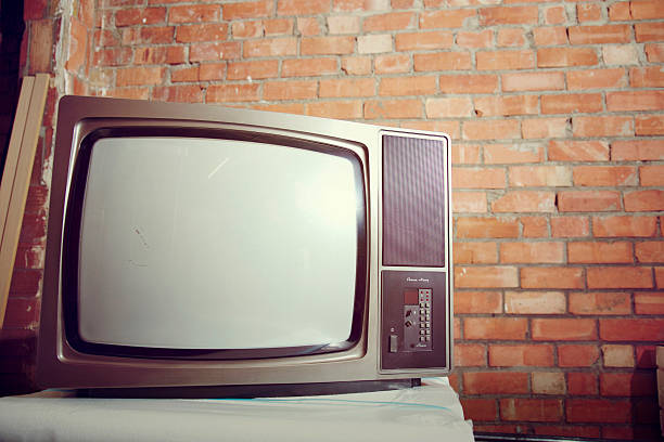 istock Old analogue television white screen on a brick warehouse 502321726