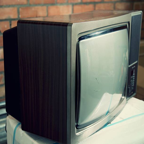 istock Old analogue television white screen on a brick warehouse 502321742