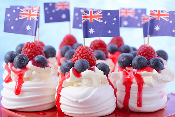 Australian Mini Pavlovas and flags Australian mini pavlovas and flags in red, white and blue for Australia Day or national holiday party food treats. australia day flag stock pictures, royalty-free photos & images