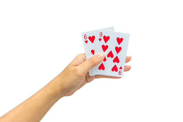 istock Playing cards in hand isolated on white background 502323094