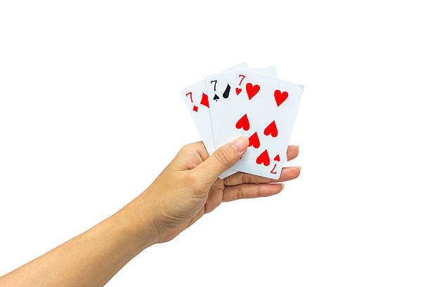 istock Playing cards in hand isolated on white background 502323178