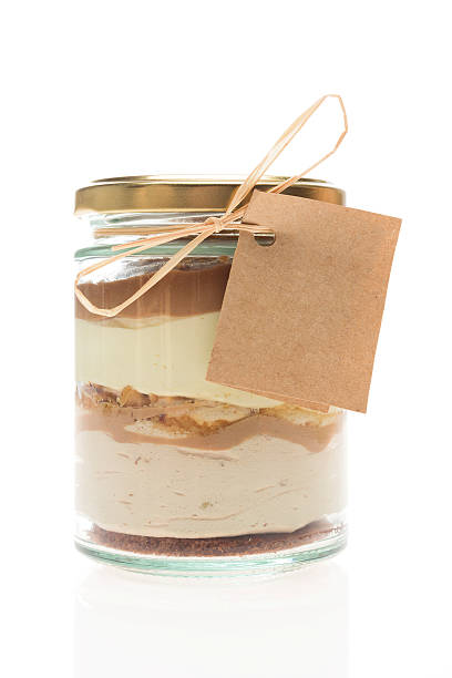 Cake in a jar Studio shoot of Cake in a jar isolated on white background cake jar stock pictures, royalty-free photos & images