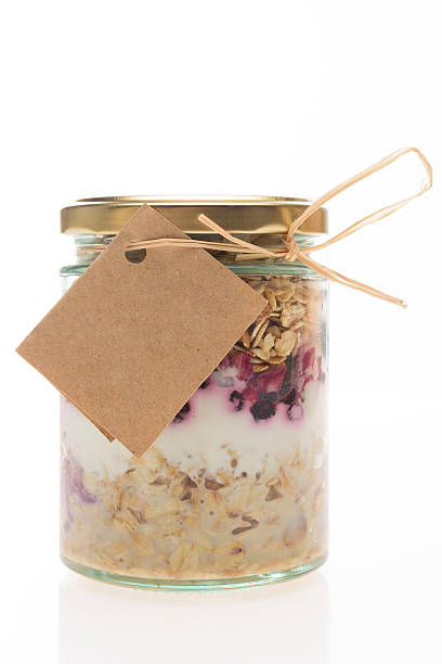 Healthy breakfast in a jar Studio shoot of Healthy breakfast in a jar isolated on white background cake jar stock pictures, royalty-free photos & images