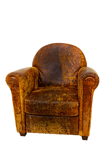 Classic Old Brown Yellowish leather armchair isolated on white background. The armchair it is extremely used and it shows parts of it that are broken. Portrait picture, color. Time and people passed on this old armchair and it keeps the memory of each and everyone.