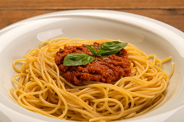 istock spaghetti bolognese on wood table 502328178