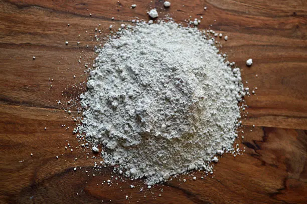 Diatomaceous Earth against a wooden background
