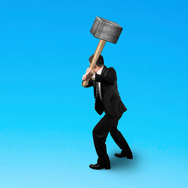 istock Businessman holding a sedge hammer 502345217