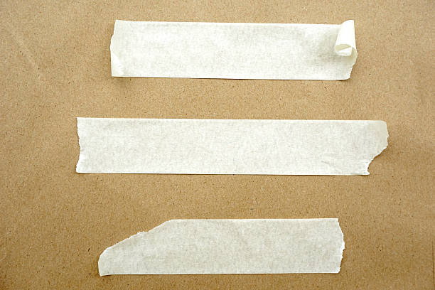 istock Brown paper with white tape for background 502345297