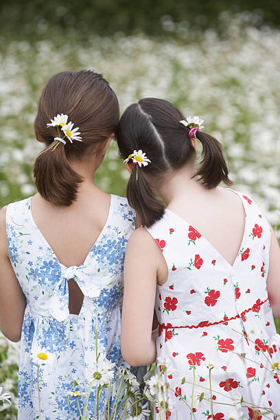 istock Girls Standing In Flower Meadow 502347301