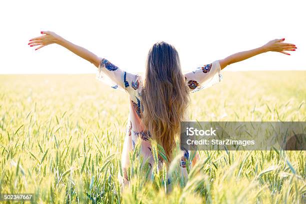 Woman With Arms Outstretched In Wheat Field Stock Photo - Download Image Now - Adult, Adults Only, Agricultural Field