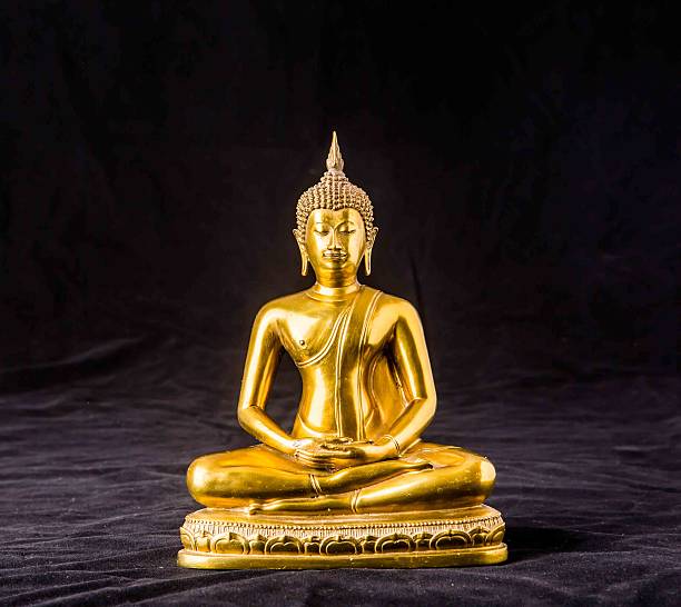 istock buddha statue isolated on black background 502349566
