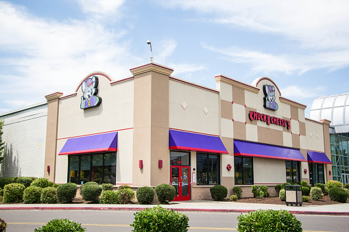 Eugene, Oregon, USA - July 8, 2014: Chuck E Cheese restaurant location in Eugene, Oregon. Chuck E Cheese is a family oriented restaurant primarily focusing on children with arcades, rides, and a prime spot for birthday parties across the United States with more than 500 locations.