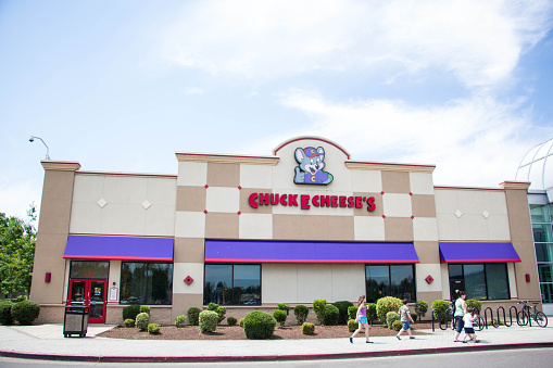 Eugene, Oregon, USA - July 8, 2014: Chuck E Cheese restaurant location in Eugene, Oregon. Chuck E Cheese is a family oriented restaurant primarily focusing on children with arcades, rides, and a prime spot for birthday parties across the United States with more than 500 locations.
