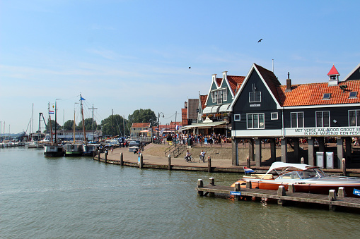 Volendam, Netherlands - August 20, 2015: Boats docked in the harbour at Volendam, a protected area due to a breakwater encompassing the waterfront.