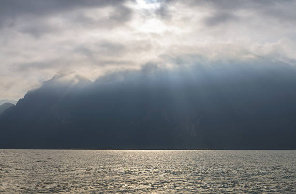 istock Sun rays streaming down onto the lake with mountain background 502351805