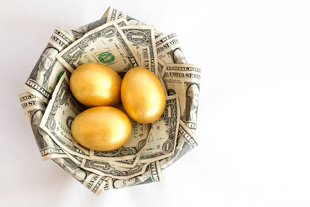istock Top view of three golden eggs in a dollar nest 502352168