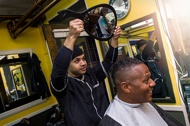 istock Barber shows haircut with mirror to client. 502352690