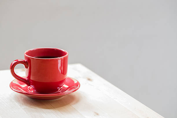istock Red coffee cup on wood background 502354518