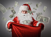Santa Claus and sack with dollars.