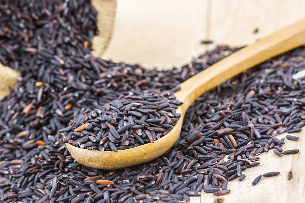 istock Rice berry in a wooden spoon and small burlap sack. 502363428