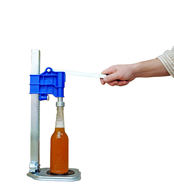 bottle capping machine on table stock photo