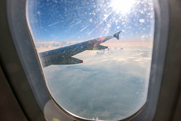 istock Clouds and sky as seen through window of an aircraft 502364952