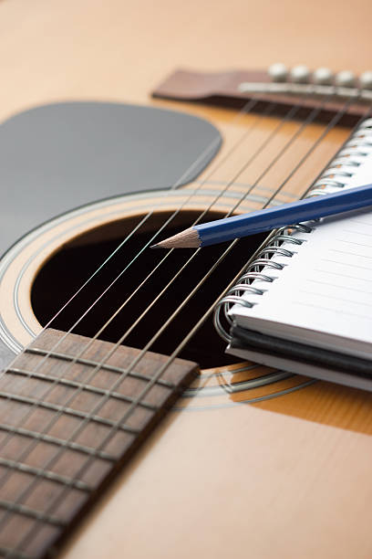 istock Notebook and pencil on guitar 502375823
