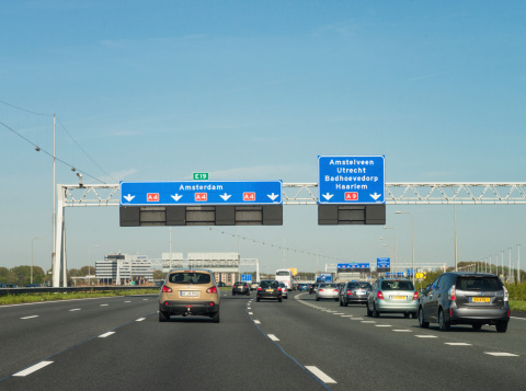 Amsterdam, The Netherlands - April 16, 2014: People travelling on the A4 motorway on the south-western outskirts of Amsterdam.