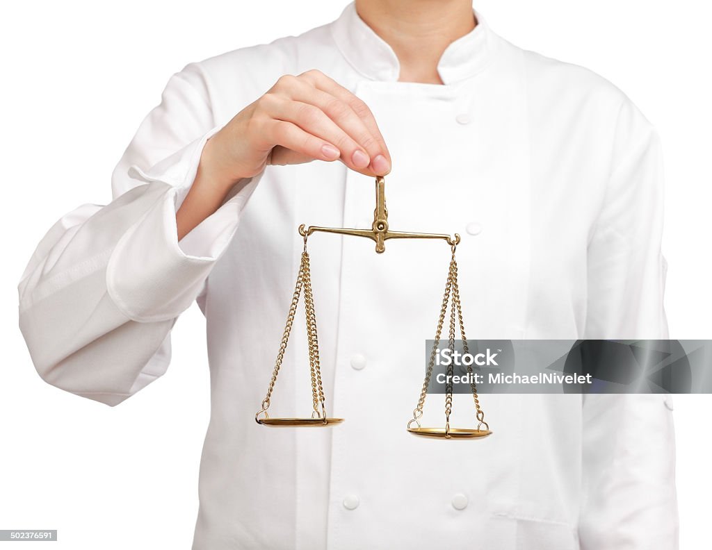 cook holding a scale of justice Photograph of a bust cook holding a scale of justice Adult Stock Photo
