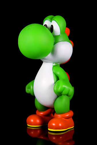 Vancouver, Canada - October 4, 2012: Yoshi from the Nintendo Super Mario franchise of games, posed against a black background. The toy is from Banpresto Company.