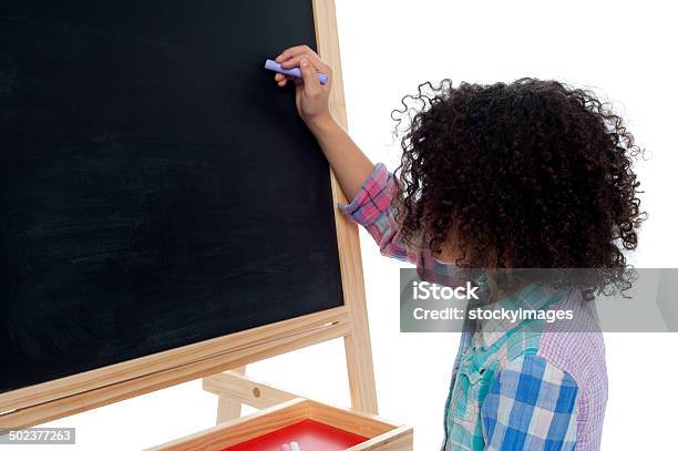 Young School Child Writing On Blackboard Stock Photo - Download Image Now - Beautiful People, Beauty, Casual Clothing