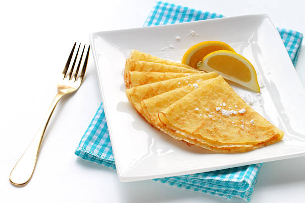 istock Homemade pancakes with lemon garnish and dusted with sugar 502377451