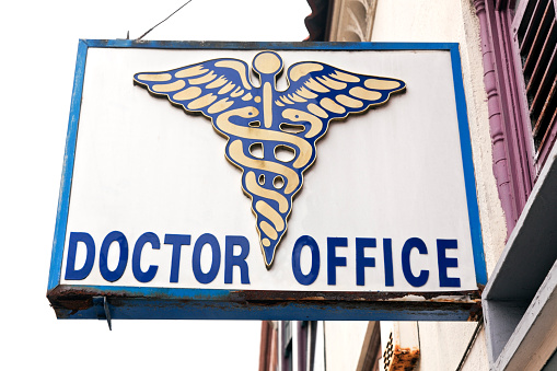 Doctor Office Sign with caduceus on side of building. Horizontal.