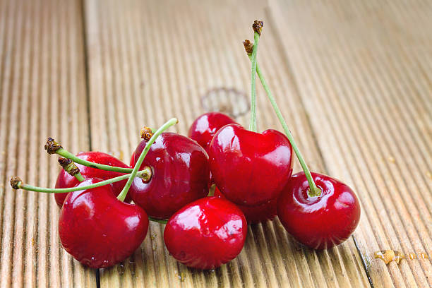 istock Ripe cherries on a wooden background 502377915