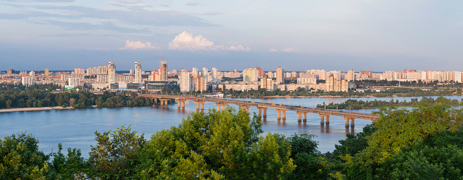 Kyiv, Ukraine - June 2, 2014: Paton bridge over river Dniepro. Panorama was made of six shots. The bridge was built between 1941 and 1953. The bridge is the world's first all-welded bridge. Traffic across the bridge was opened on 5 November 1953. The bridge also acts as a segment of the Small Ring Road of Kiev.