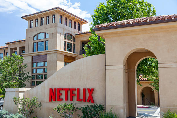 Netflix Headquarters Los Gatos, USA - July 16, 2014: Headquarters of internet movie pioneer Netflix, located at 100 Winchester Circle in Los Gatos, CA. The world-renown company was started in 1997, offering it's no late-fee, subscription based DVD-by-mail service which has grown to a collection of over 100,000 movie titles and over 23 million subscribers. In 2010, Netflix reached a deal with Hollywood movie companies allowing it to offer on-demand internet streaming. 2000 photos stock pictures, royalty-free photos & images