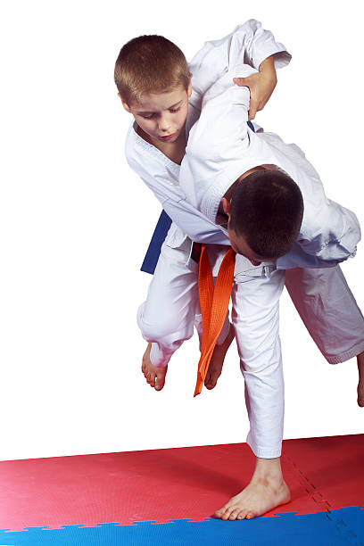 istock Athlete with orange belt is doing judo throw 502380089