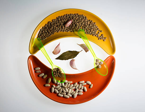 variety of legumes and two spoons on cereamic