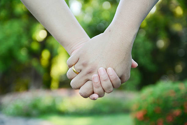 Two Pairs Of Hands In Love Tenderly Hold Together Stock Photo