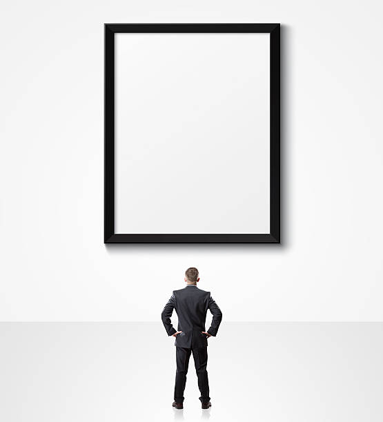istock businessman looking up at empty poster 502384732