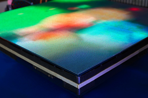 Side of the panel of LED SMD screen with bright green colors - blurred background